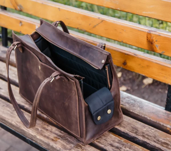Designed for both fashion and functionality, this high-end leather pet carrier allows you to travel in style with your furry friend. This all-in-one pet travel bag provides a safe, cosy, and stylish way to take your dog or cat with you, whether you're going to the vet, going on a weekend trip, or just going for a stroll. This dog tote bag carrier is made of premium leather and has a roomy, airy interior, sturdy handles, and a plush lining for your pet's comfort. While the multipurpose pockets provide room for snacks, leashes, and necessities, the structural design maintains its shape. It's ideal for small to medium-sized pets and blends in perfectly with your everyday routine. You may use it as a dog walking bag, cat carrier, or easy travel bag for dogs.